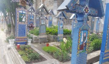 Colorful cemetery with artistically painted grave markers.
