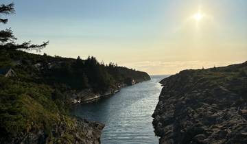 A scenic view of a narrow waterway leading to the sea.