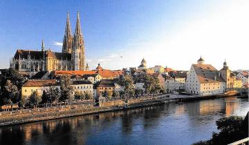 Scenic view of a historic city with a cathedral and river.