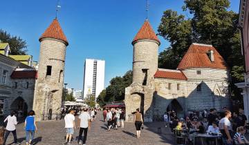 Busy street scene with an old stone building.