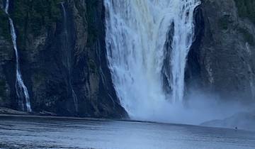 Large waterfall with a bridge above.