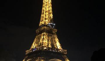 Eiffel Tower illuminated at night.