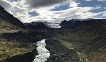 River winding through a deep valley with snowy peaks.