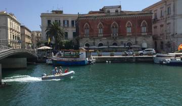 Coastal town with boats and historic buildings.