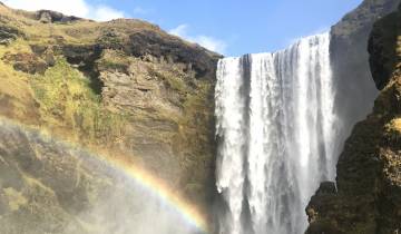 Waterfall with rainbow in the foreground.