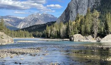 Tranquil river landscape with mountains and forests.