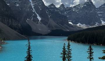 Moraine Lake surrounded by mountains and forests.