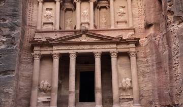 Tourists and camels in front of the Treasury in Petra.