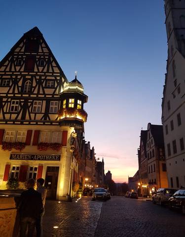 A historic building with intricate architecture illuminated at night.