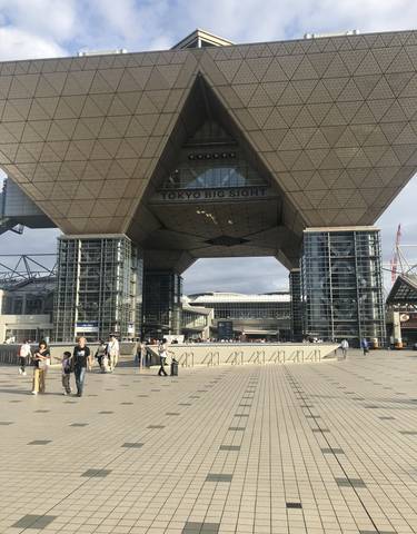 People walking in front of Tokyo Big Sight entrance.