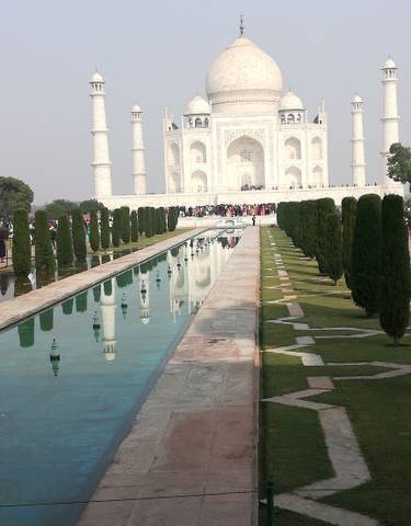 Taj Mahal with reflective pool and visitors.
