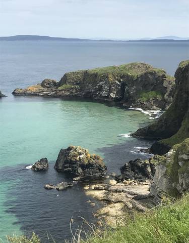 Turquoise bay surrounded by rocky cliffs.