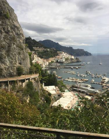 Panoramic view of Amalfi Coast with buildings on cliffs.