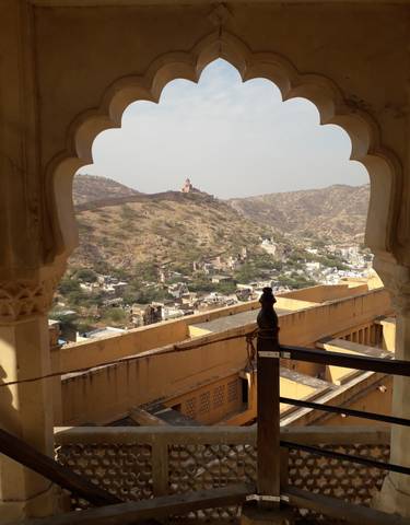 Expansive view of a fort and town surrounded by hills.