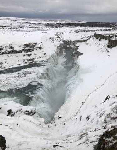 Frozen waterfall in a snowy landscape