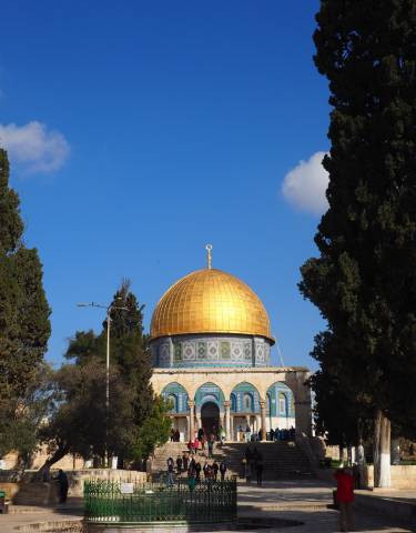 Close-up of the Dome of the Rock under blue sky.