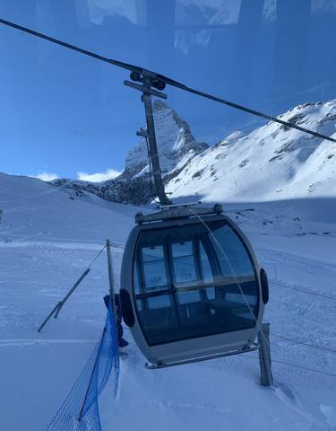 Cable car in snowy mountain landscape.
