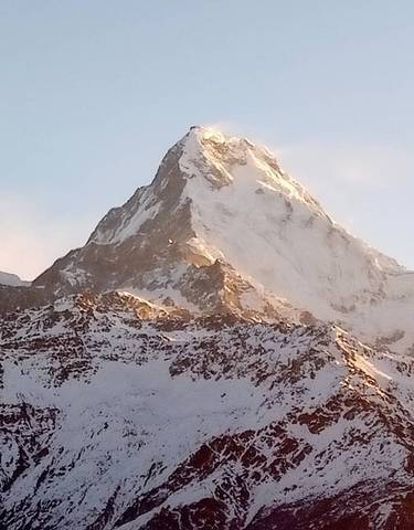 Close-up of a snow-capped peak under sunlight.