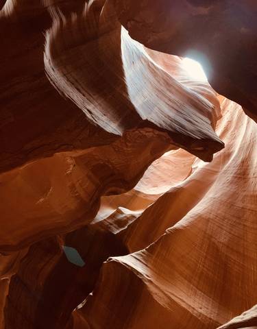Narrow slot canyon with light filtering through.