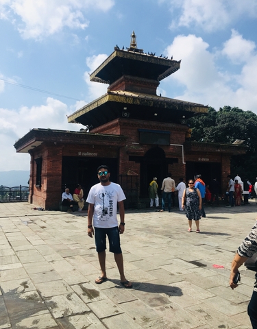 Tourists outside a traditional building with intricate designs.