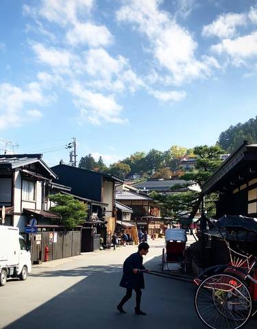 Charming street scene in Japan with traditional buildings and people.