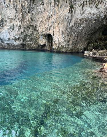 Crystal clear waters in a rocky cove.