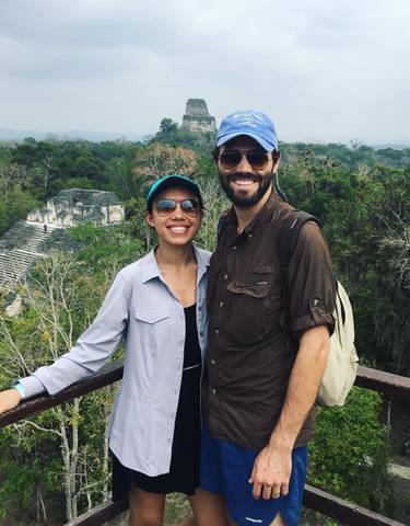 Couple on a lookout with an ancient temple visible in the background.