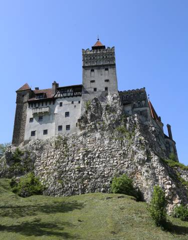 Bran Castle, an iconic fortress on a rocky hill.