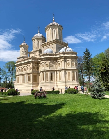 Grand architectural building with tourists around.