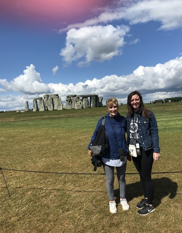Two women in front of the Stonehenge monument.