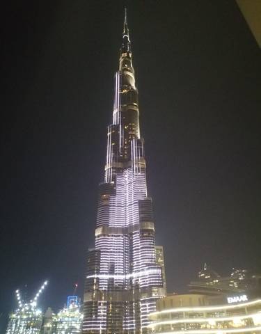 Night view of a tower lit up against a dark sky.