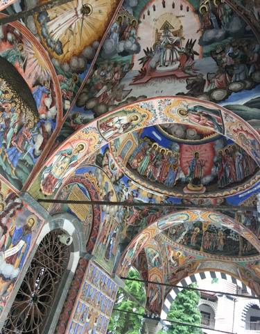Colorful frescoes on a church ceiling.
