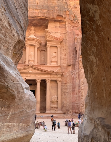 Majestic view of Al-Khazneh with sandstone cliffs.