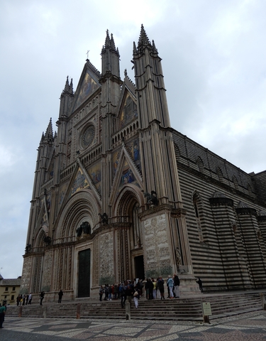 Facade of a gothic style cathedral with intricate designs.