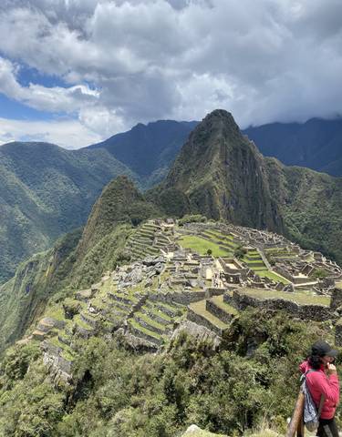 Panoramic view of Machu Picchu with mountains in the background.