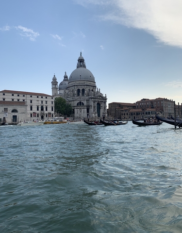 Gondolas and Venice architecture along a canal.