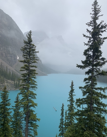 Stunning view of a turquoise lake surrounded by mountains.
