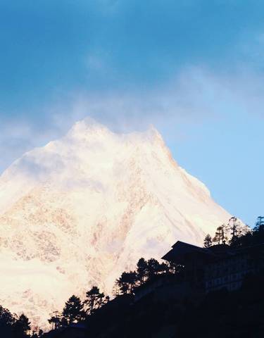 Snow-covered mountain peak with early morning light.