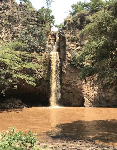 A waterfall surrounded by rocky cliffs
