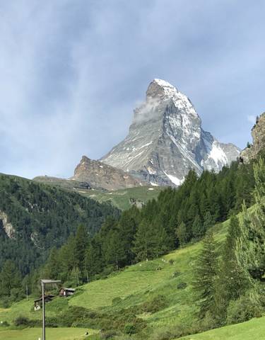 Dramatic peak of a snow-capped mountain under clear skies.
