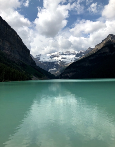 Turquoise lake with a mountainous backdrop.