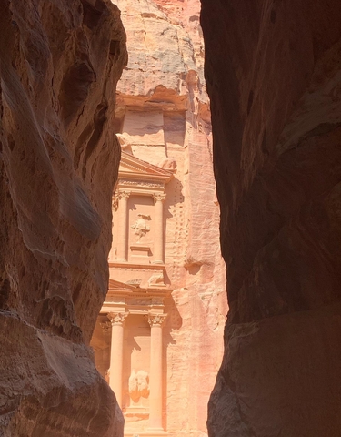 The Treasury at Petra viewed through a narrow canyon.