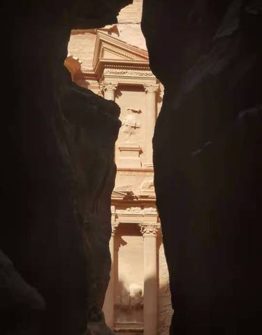 The Siq canyon with a glimpse of the Treasury in Petra.