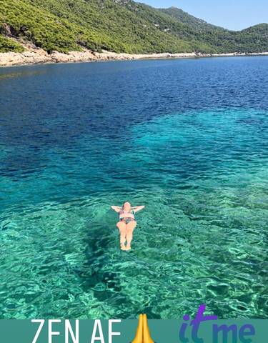 Person enjoying a swim in clear blue water.