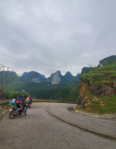 Group of travelers on a scenic mountain road.
