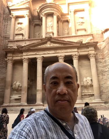 Front view of a historical carved building.