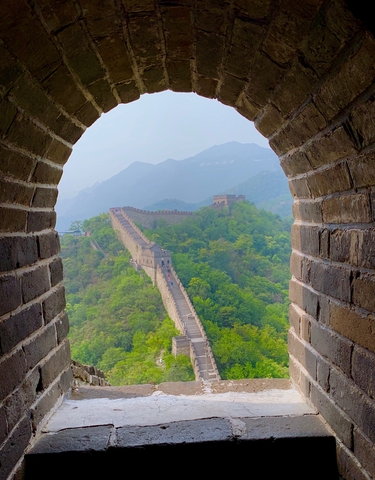 View of the Great Wall of China through an archway.