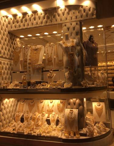 A luxurious shop window displaying a collection of gold jewelry.