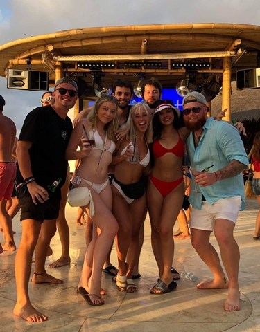 Group of people at a beach bar having drinks.