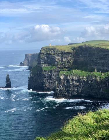 Cliffs with greenery overlooking the ocean.